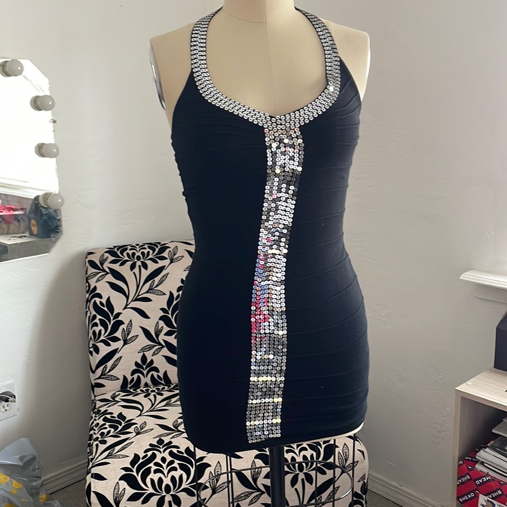 Black dress, strapless but it has a over head strap.